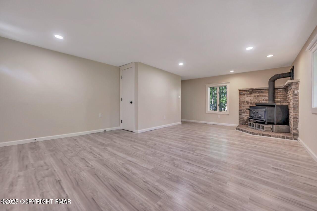 2128 Faratol Road East Stroudsburg, PA 18302 - Photo 53 of 85 a view of empty room with wooden floor and fireplace