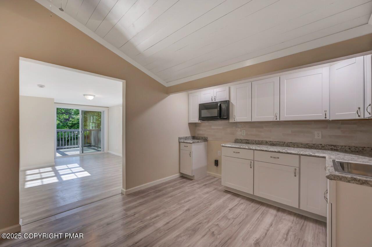 2128 Faratol Road East Stroudsburg, PA 18302 - Photo 66 of 85 a kitchen with stainless steel appliances granite countertop a stove a sink and white cabinets with wooden floor