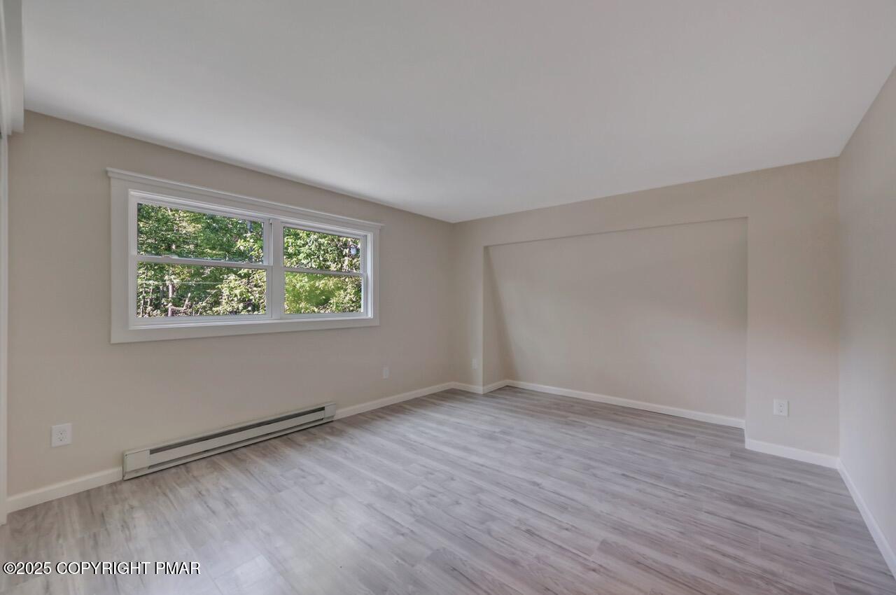 2128 Faratol Road East Stroudsburg, PA 18302 - Photo 70 of 85 an empty room with wooden floor and windows