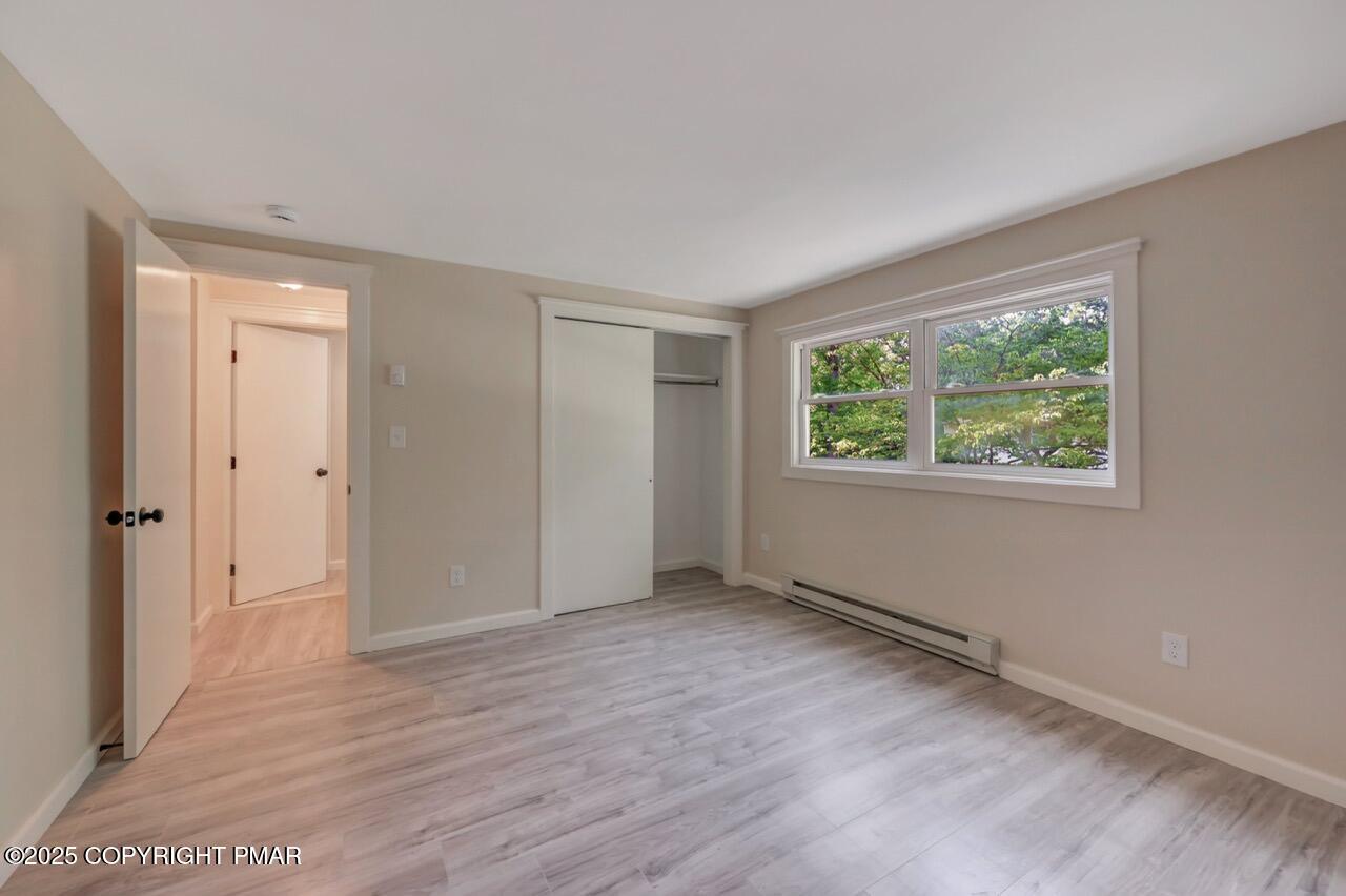 2128 Faratol Road East Stroudsburg, PA 18302 - Photo 71 of 85 a view of an empty room with wooden floor and a window