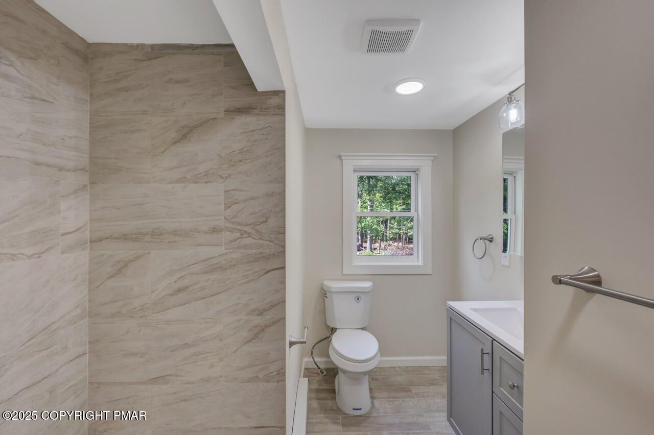 2128 Faratol Road East Stroudsburg, PA 18302 - Photo 72 of 85 a bathroom with a toilet a sink and window