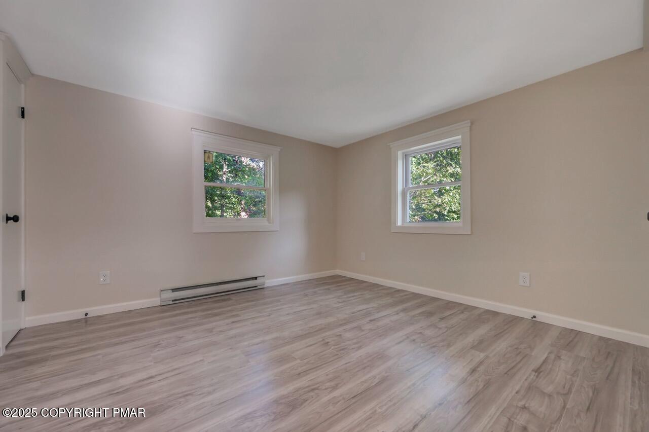 2128 Faratol Road East Stroudsburg, PA 18302 - Photo 76 of 85 an empty room with wooden floor and windows