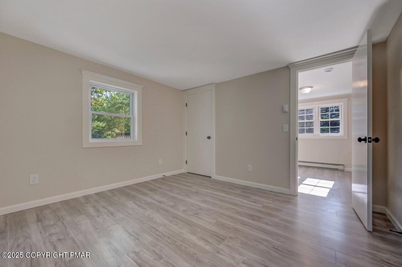 2128 Faratol Road East Stroudsburg, PA 18302 - Photo 77 of 85 an empty room with wooden floor and windows