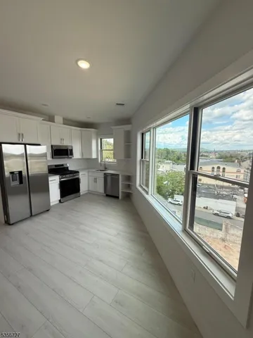 a view of a kitchen with a sink and dishwasher cabinets