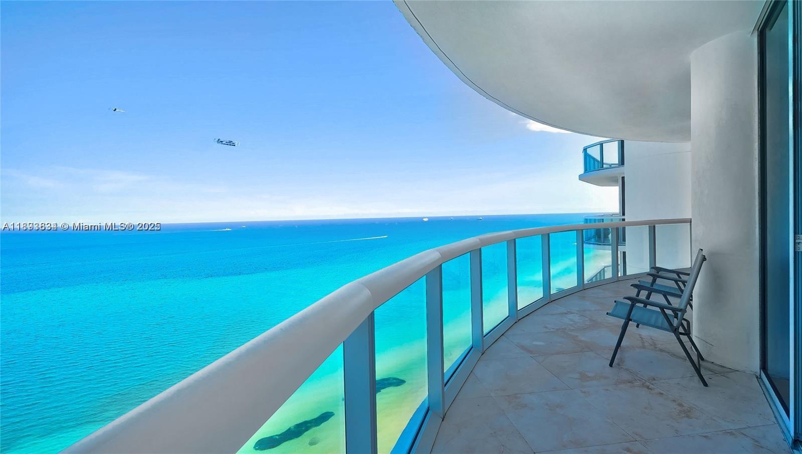 a balcony with view of an ocean