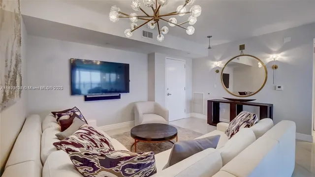 a living room with furniture and a mirror