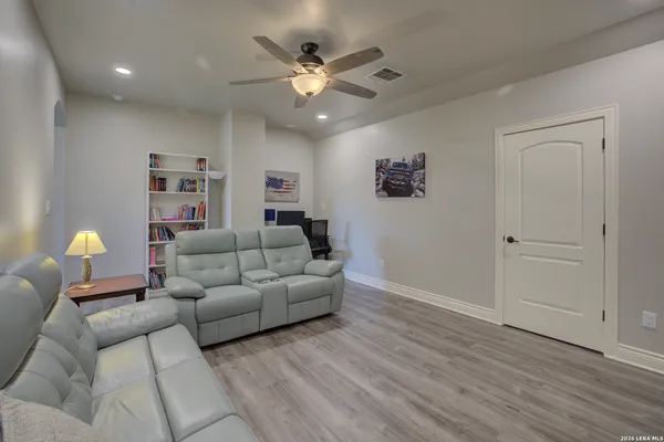 a living room with furniture and a ceiling fan
