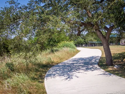 an aerial view of a house with a yard and lake view
