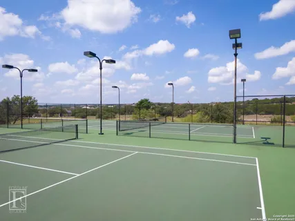 a living room with furniture and a refrigerator