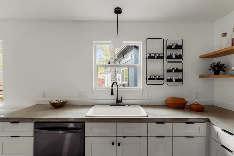 a kitchen with a sink and cabinets