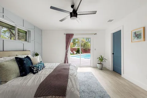 a bedroom with a bed and a potted plant