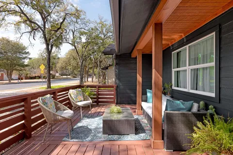 a view of patio with a table and chairs and wooden floor