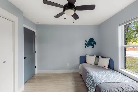 a bedroom with a bed and a potted plant