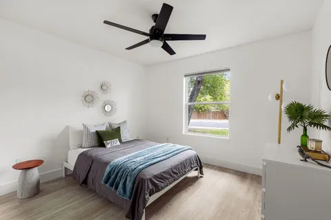 a bedroom with a bed and a window