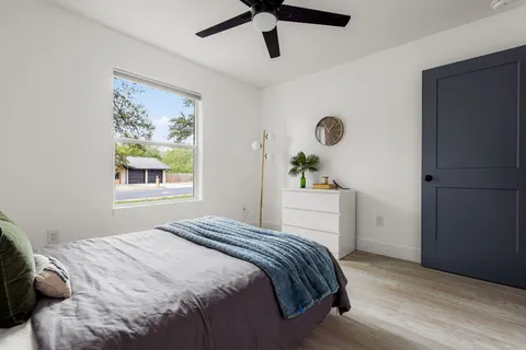 a bathroom with a granite countertop sink a toilet and a mirror