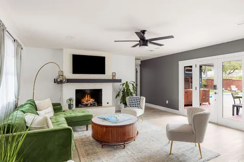 a living room with furniture a fireplace and a flat screen tv
