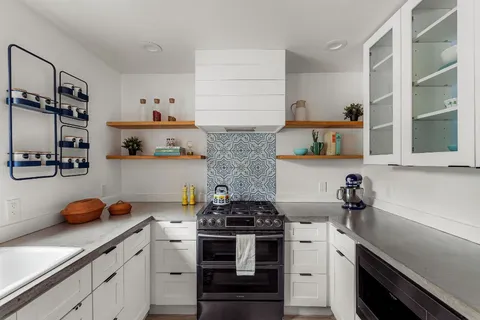 a kitchen with stainless steel appliances and cabinets