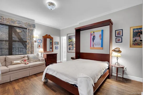a spacious bedroom with a bed a couch and a window