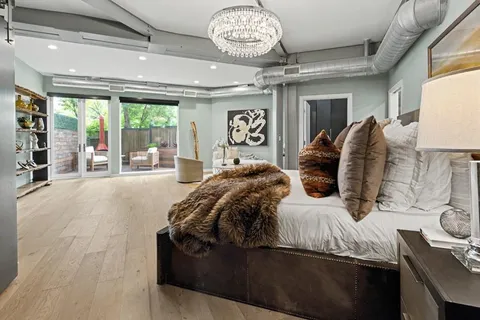 a bed sitting in a bedroom next to a balcony