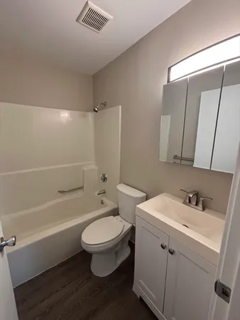a bathroom with a sink toilet a mirror and shower