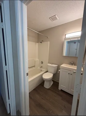 a white toilet sitting next to a bathroom sink