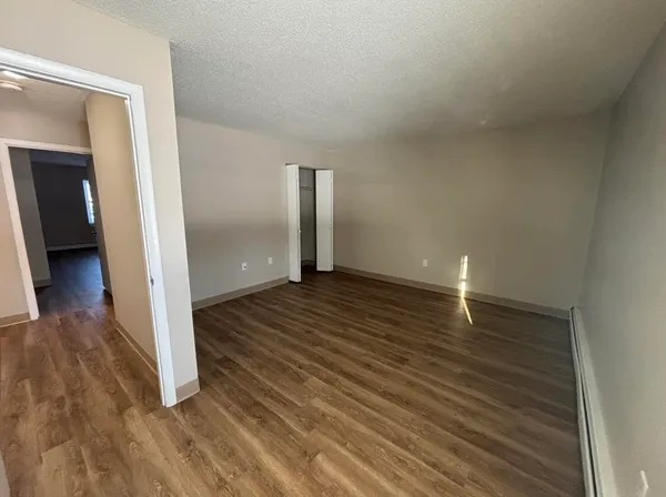 a view of a room with wooden floor