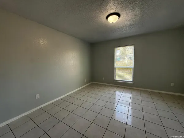 an empty room with white walls and tiles