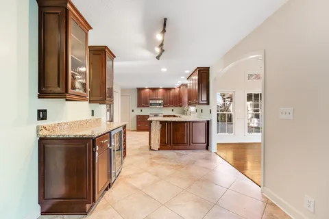 a kitchen with stainless steel appliances granite countertop a refrigerator and a sink