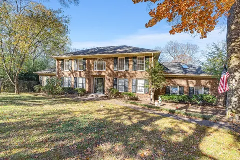 a view of a house with a yard patio and fire pit