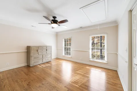 a spacious bedroom with a bed and a chandelier