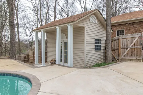 a view of wooden floor and a chandelier fan in a room