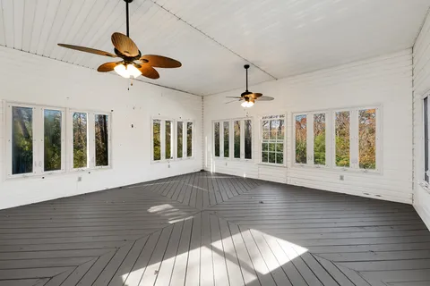 a view of a chairs and table in the back yard of the house