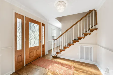 a view of an entryway with wooden floor and windows