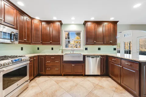 a large kitchen with a large counter top and appliances
