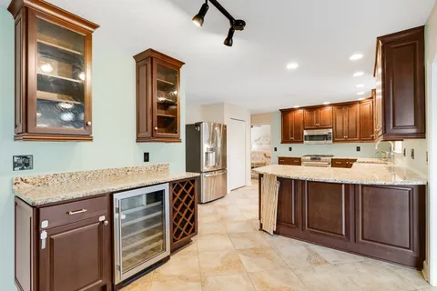 a kitchen with a stove sink and cabinets