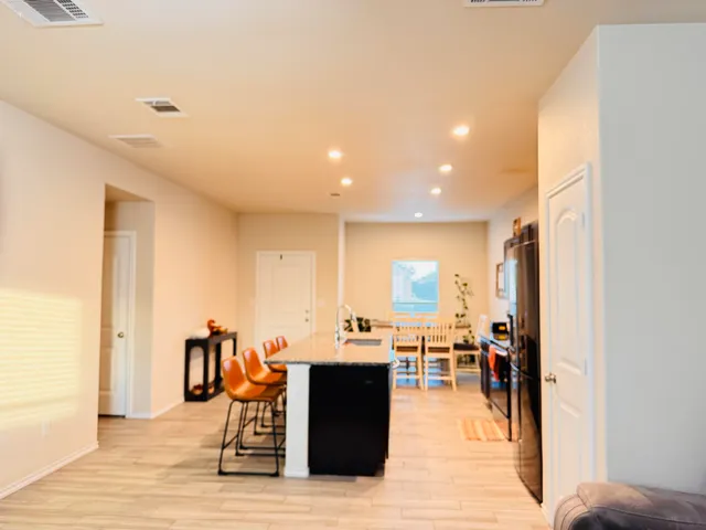 a living room with lots of furniture and kitchen view