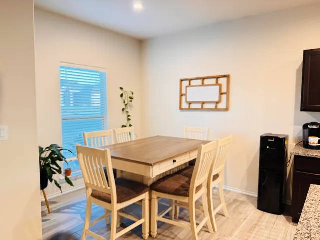 a view of a dining room with furniture and a flat screen tv
