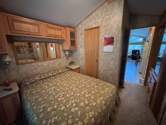 a bedroom with a bed and dresser