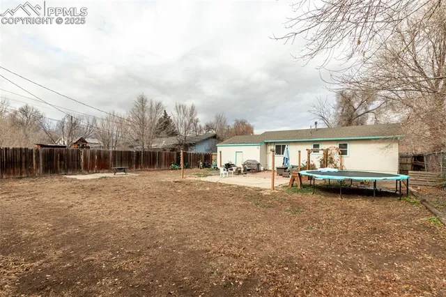 a view of a house with backyard and sitting area
