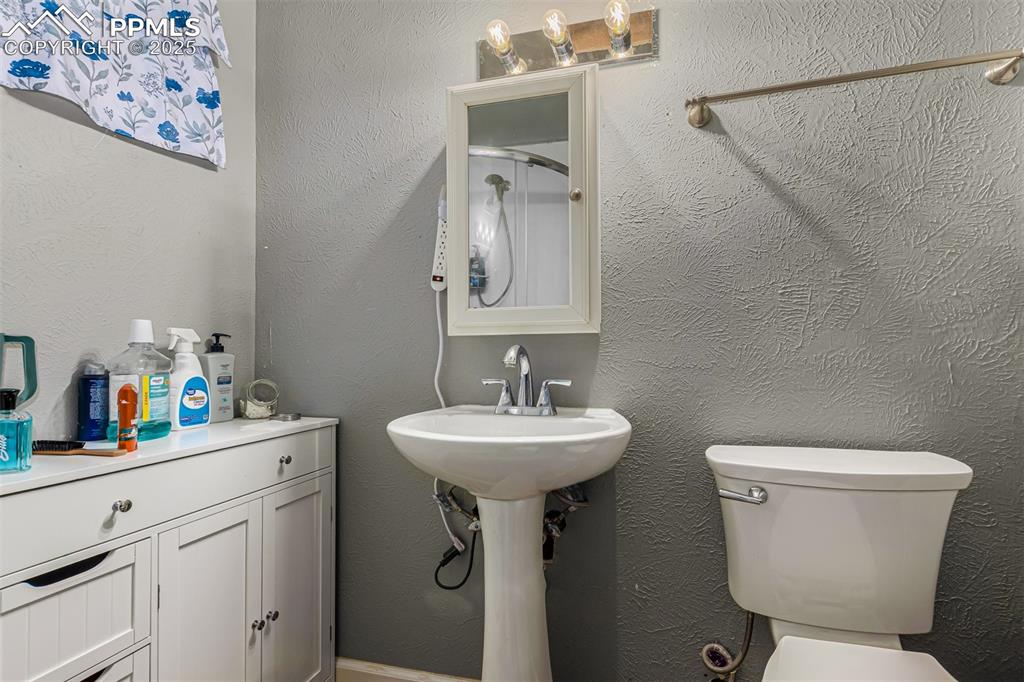 342 Mt View Lane Fountain, CO 80817 - Photo 5 of 17 a bathroom with a sink toilet and a mirror