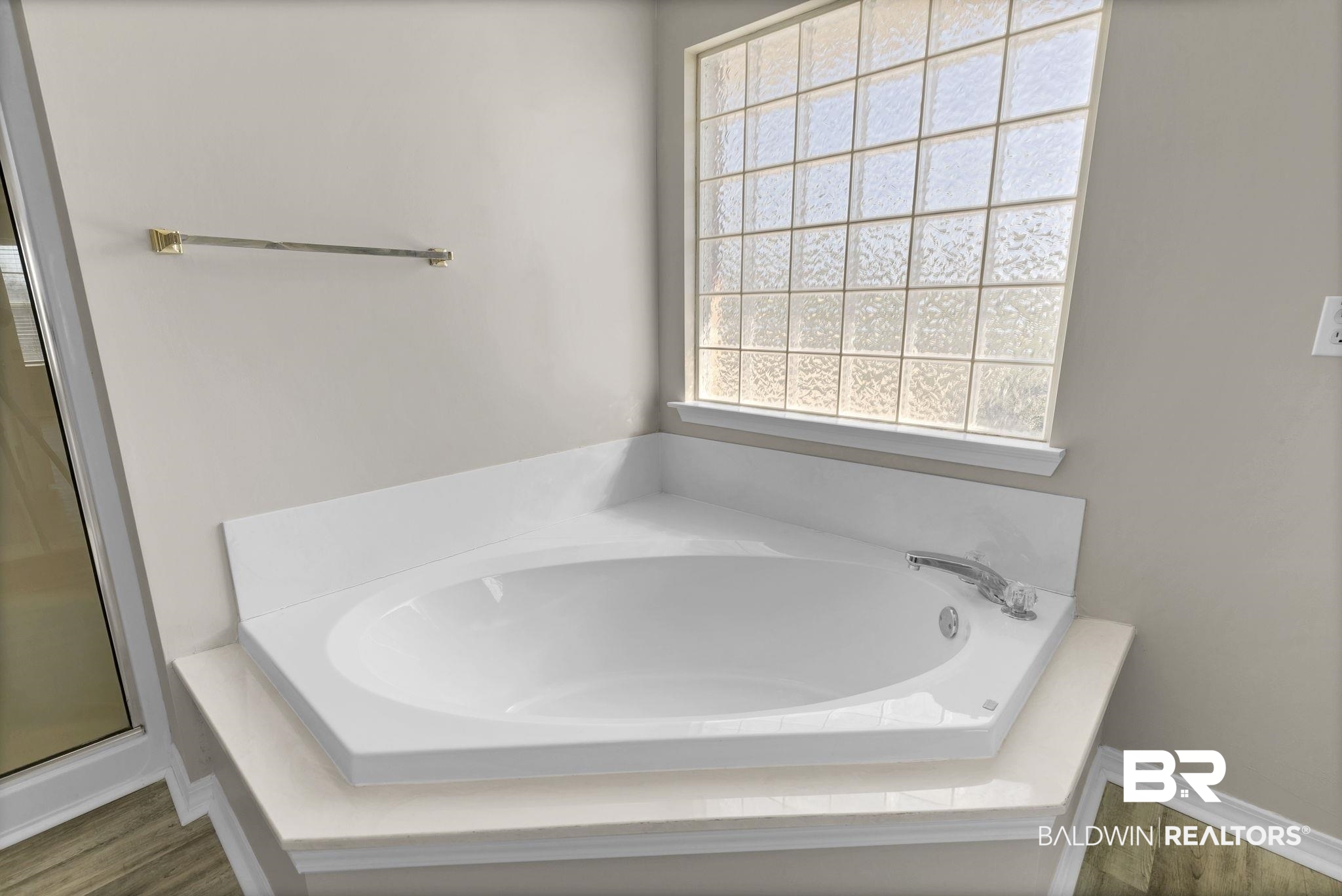 10238 Grove Drive Fairhope, AL 36532 - Photo 18 of 39 Bathroom with 2 closets, a garden tub, separate shower, private water closet, wood finished floors, and double vanity.
