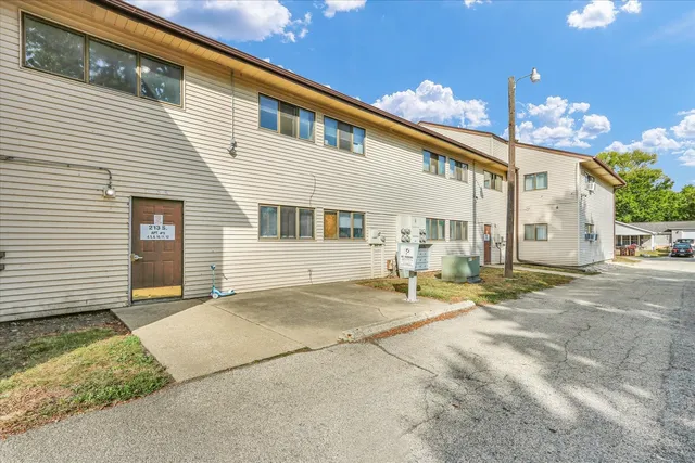 a view of a house with a yard and garage