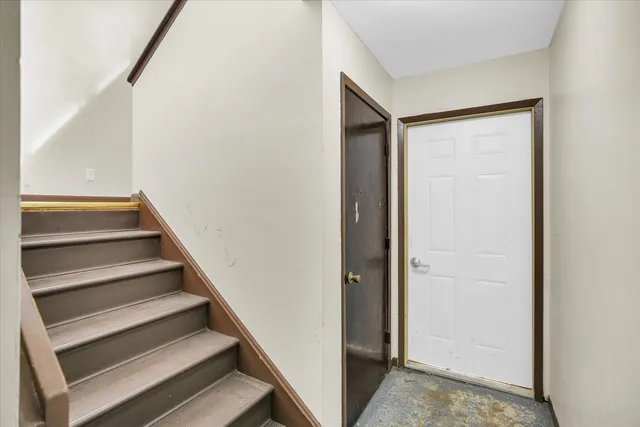 an empty room with windows and closet