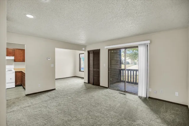 a kitchen with a refrigerator a stove top oven a sink and a window