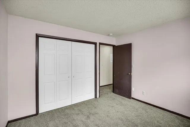 a view of a white house with a yard and garage