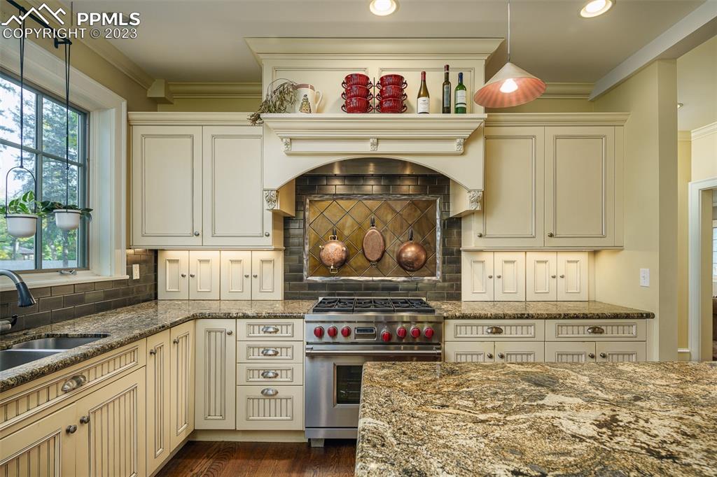 7 5th Street Colorado Springs, CO 80906 - Photo 13 of 46 a kitchen with stainless steel appliances a stove top oven and cabinets