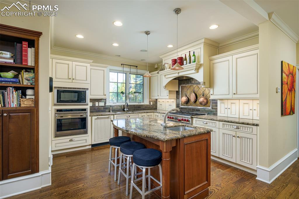 7 5th Street Colorado Springs, CO 80906 - Photo 14 of 46 a kitchen with a stove a refrigerator and a refrigerator