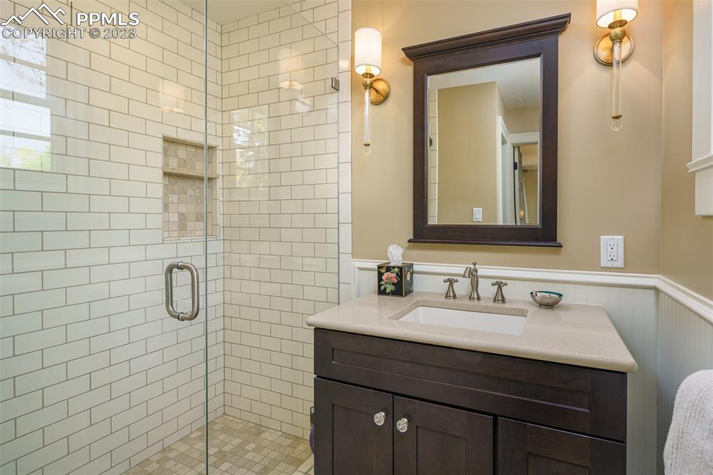 7 5th Street Colorado Springs, CO 80906 - Photo 18 of 46 a bathroom with a sink vanity and a mirror