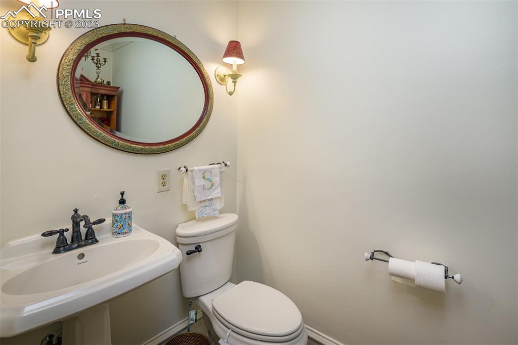 7 5th Street Colorado Springs, CO 80906 - Photo 19 of 46 a bathroom with a sink a toilet and a mirror