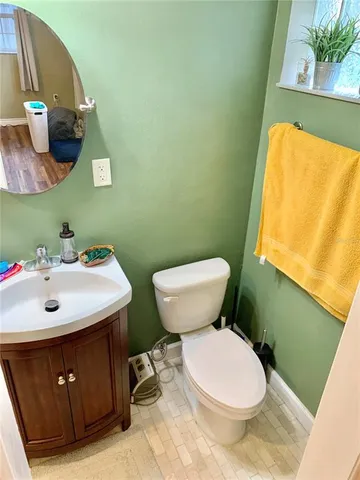 a bathroom with a sink mirror vanity and toilet